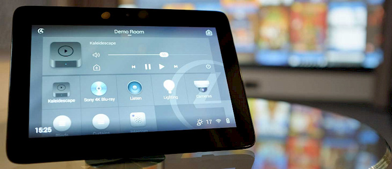 touchscreen control on ipad, with cinema screen in the background