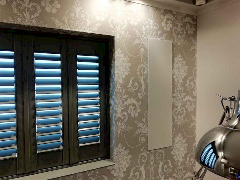 in-wall meridian dsp speaker next to a window with blue lighting