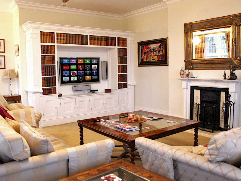 TV on wall in living room with in-wall speakers