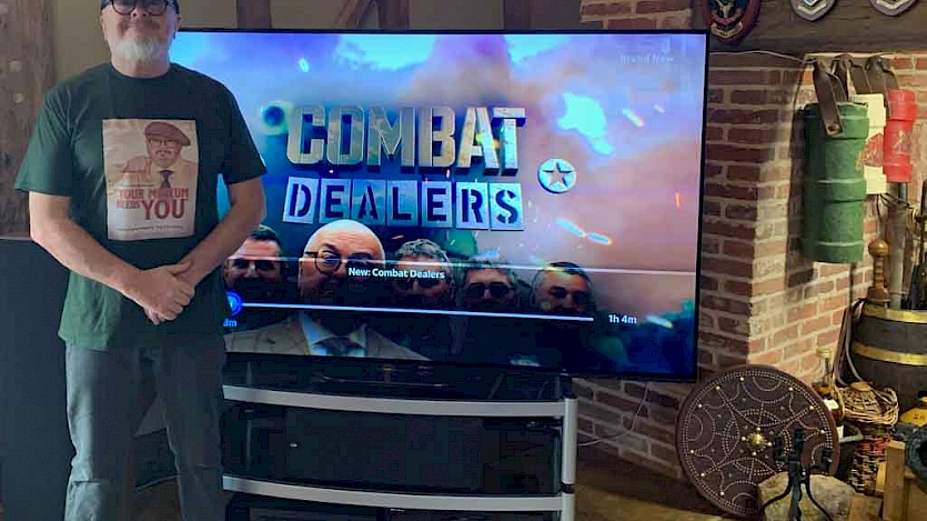 combat dealers host at home in front of his new tv